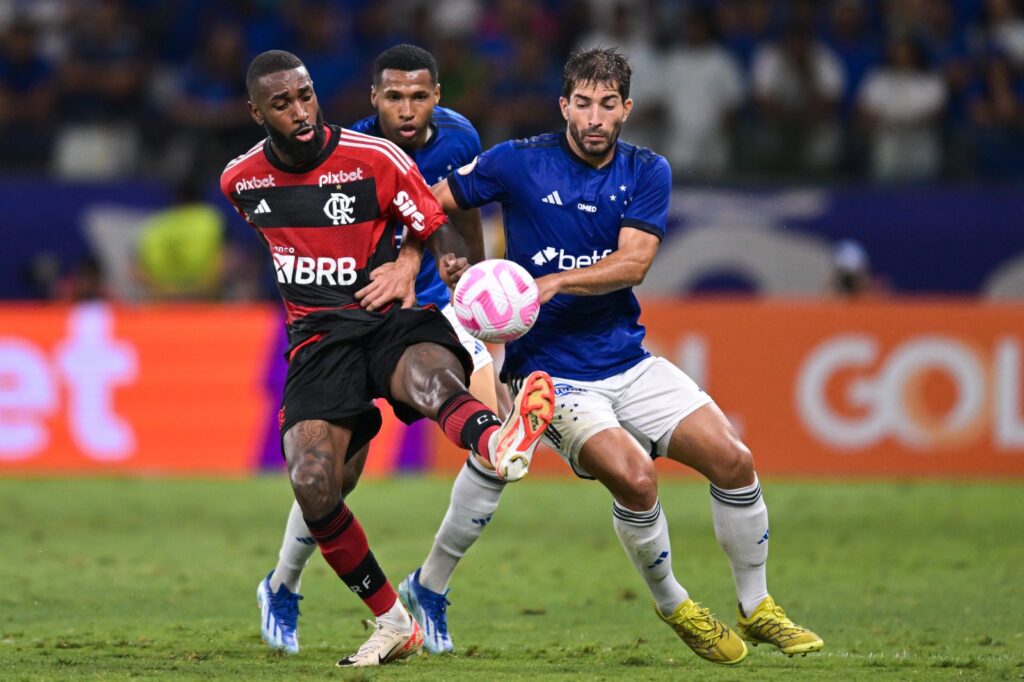 Wesley e Lucas Silva do Cruzeiro e Gerson do Flamengo brigam pela bola durante partida entre Cruzeiro e Flamengo no Brasileirão 2023